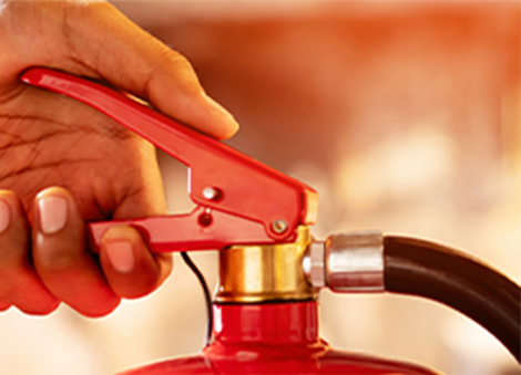 Squeeze the handle to release the extinguishing agent